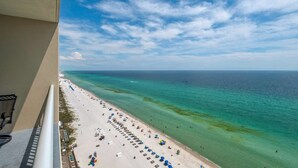 A beach with clear turquoise water and a pier in the distance. - Palazzo by iTrip Panama City Beach (Panama City Beach)