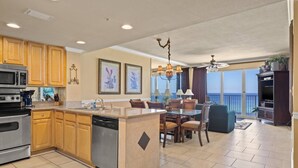 A spacious kitchen with wooden cabinets, stainless steel appliances, and a large island. - Marisol by iTrip Panama City Beach (Panama City Beach)