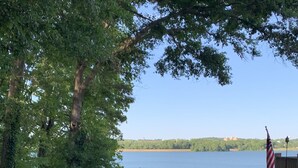 A lakeside view with a dock, an American flag, and a gazebo. - THE Premier Clemson /Seneca Lake Home  (Seneca)