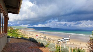 A beach view from a building with a brick pathway leading to the beach. - Luxury beach stay,  close to the famous SA wine regions (Aldinga)
