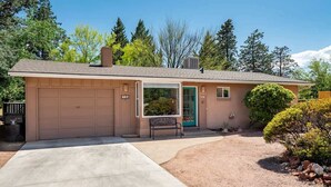 A single-story house with a garage, a front door, and a small porch. - Ranch Style Home Uptown Sedona, View/BBQ/Patio! (Sedona)