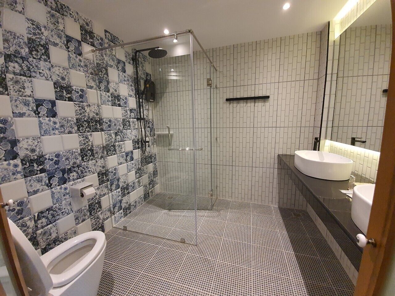 A bathroom with a shower, toilet, and sink.