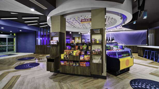 A modern retail area with a snack display and a beverage station. - Tru By Hilton Goodyear Phoenix West, AZ (Goodyear)