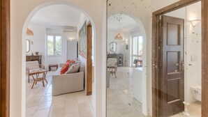 A spacious living area with a sofa, chairs, and a dining table. - Sea view pool villa w/ garden, 2km from sand (Torre Pali)