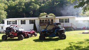 A white mobile home with a porch and a lawn. -  Trail Side Inn 4 bed 2 bath with trail access to 4 Hatfield-McCOY trails system (northfork)