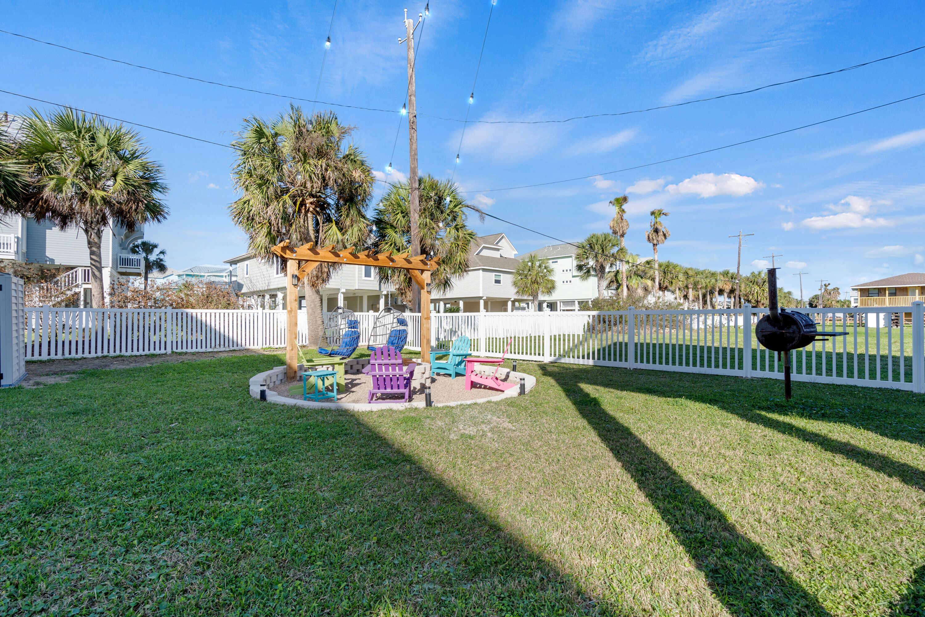 A backyard with a wooden pergola, colorful Adirondack chairs, and a barbecue grill.