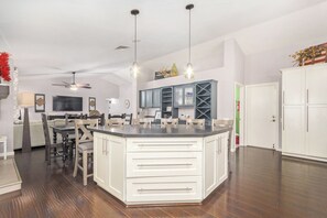 Enjoy meals in this well-equipped kitchen with a central island, dining table, and wine rack.