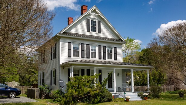 A two-story house with a porch, a chimney, and a driveway. - Irvington Country Getaway House (Irvington)