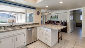 A modern kitchen with a large island, built-in appliances, and a view to the outside. - PET FRIENDLY IN QUIET NEIGHBORHOOD! (Tempe)