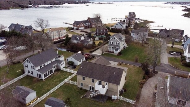 A residential area with houses, a dock, and a body of water.
