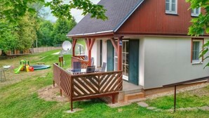 A two-story house with a wooden deck and a satellite dish. - Holiday Hill 26 by Interhome (Cerny Dul/Cista)