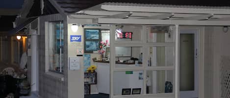 A small, single-story building with a sign indicating it is a Sky Office.