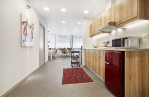 Enjoy cooking in this fully equipped kitchen with a microwave, refrigerator, and ample counter space.