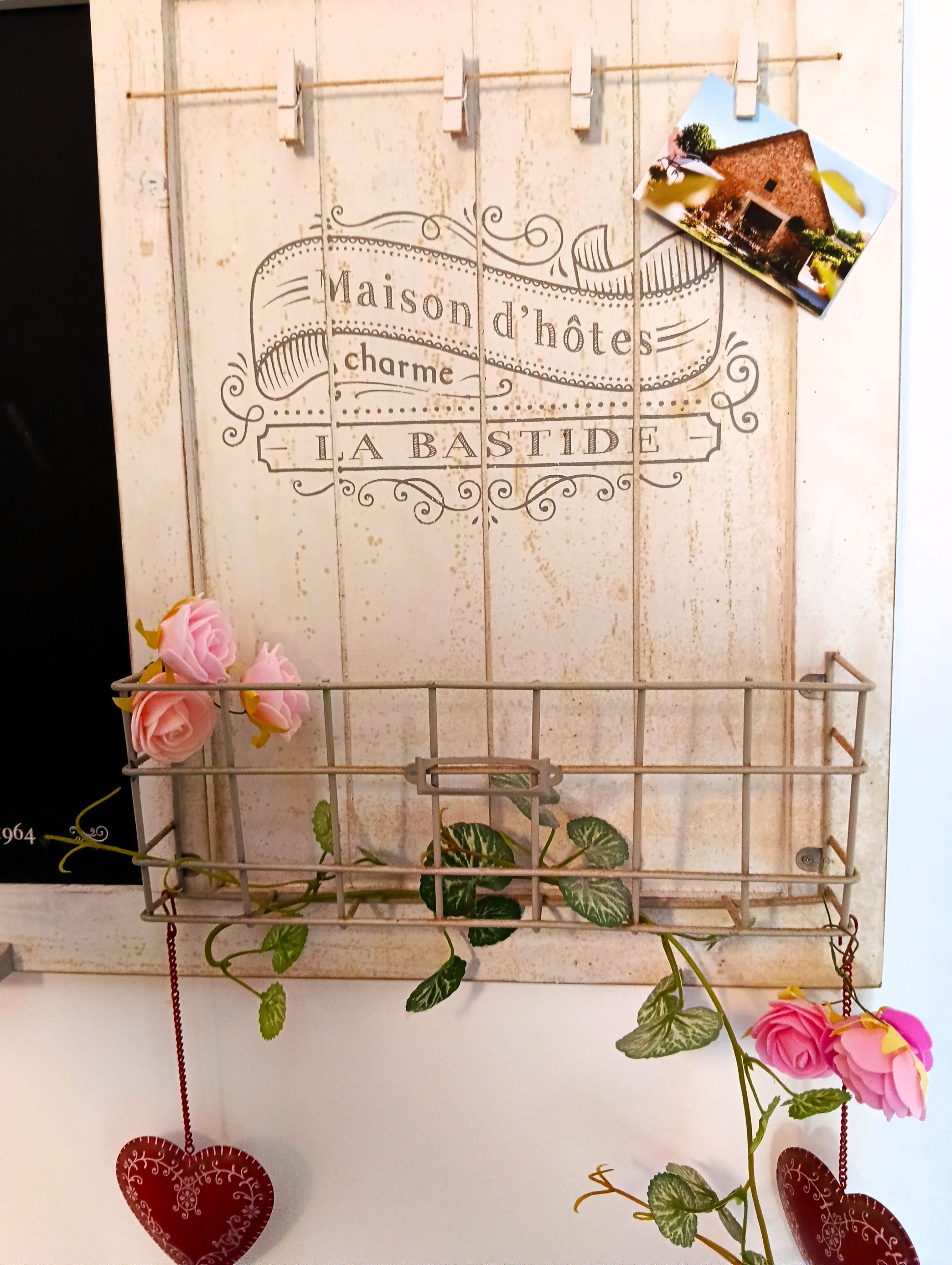 A rustic wooden wall with a sign that reads 'Maison d'hôtes charm A BASTIDIE.'