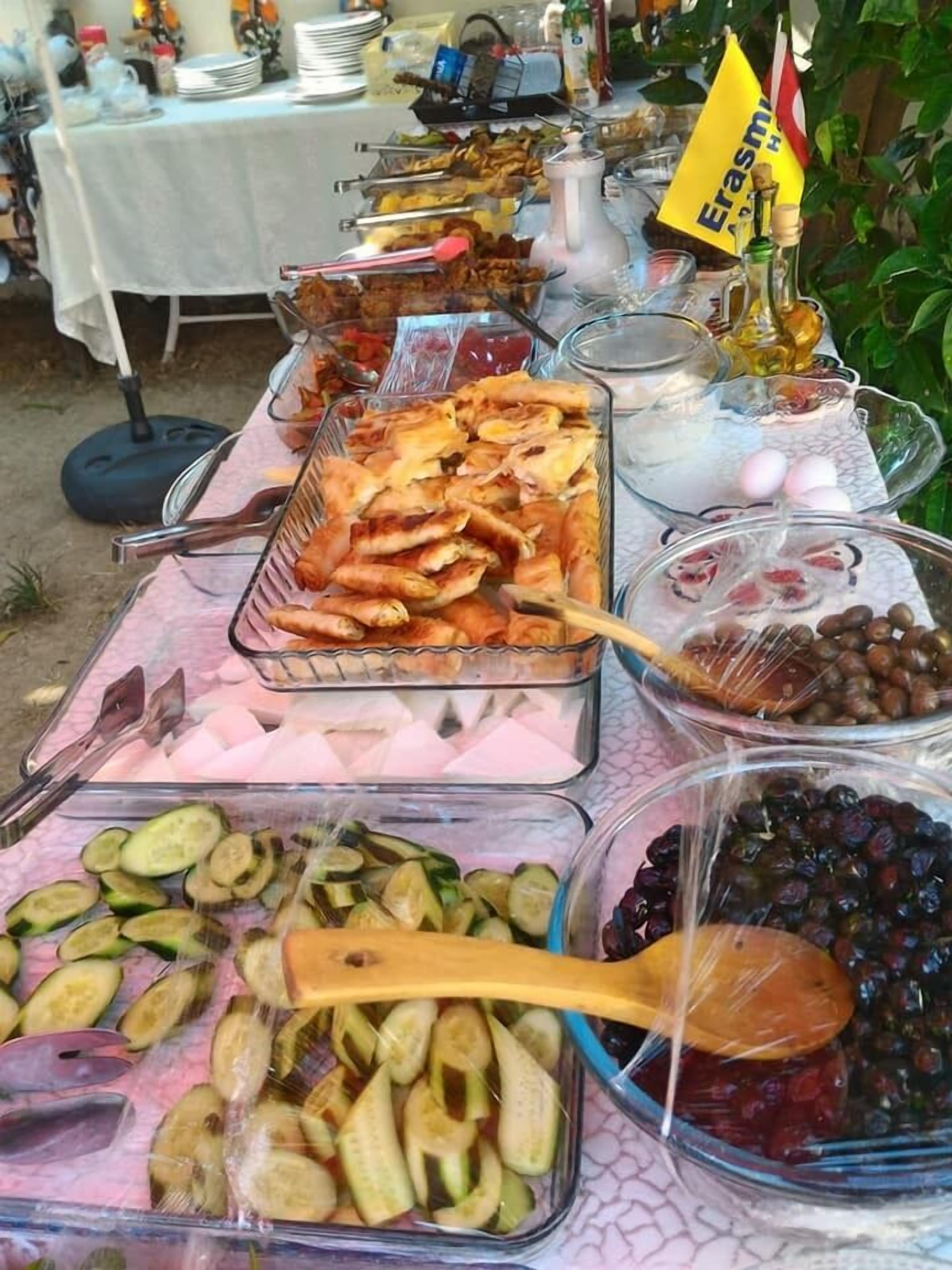 A buffet table with various food items including fruits, vegetables, and meats.