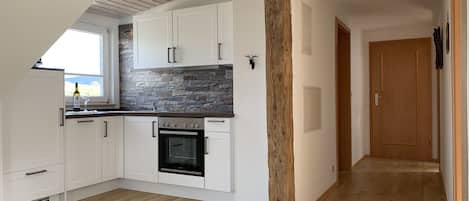 Fridge, stovetop, dishwasher, coffee/tea maker