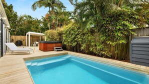A swimming pool with a wooden deck, a hot tub, and a covered seating area. - Aaloka Bay - heritage charm w. pool & spa (Byron Bay)
