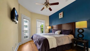 A bedroom with a bed, a ceiling fan, a TV mounted on the wall, and a window. - motley crew , when you need the space for your big group of personalities  (Myrtle Beach)