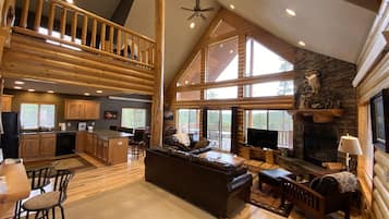 Télévision, cheminée, lecteur de DVD, baby-foot