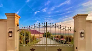 A gated entrance with a clear sky and a building in the background.