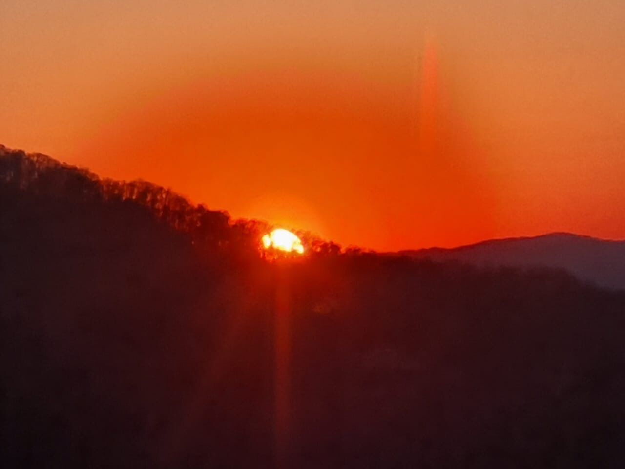 A sunset over a mountainous landscape.