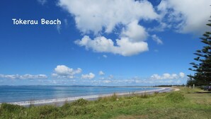 A beach with a clear sky and the text "Tokeraub Beach" visible. - Spacious Beach Home Away From Home (Tokerau Beach)