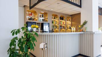 A bar area with shelves of liquor bottles, a refrigerator, and a potted plant.