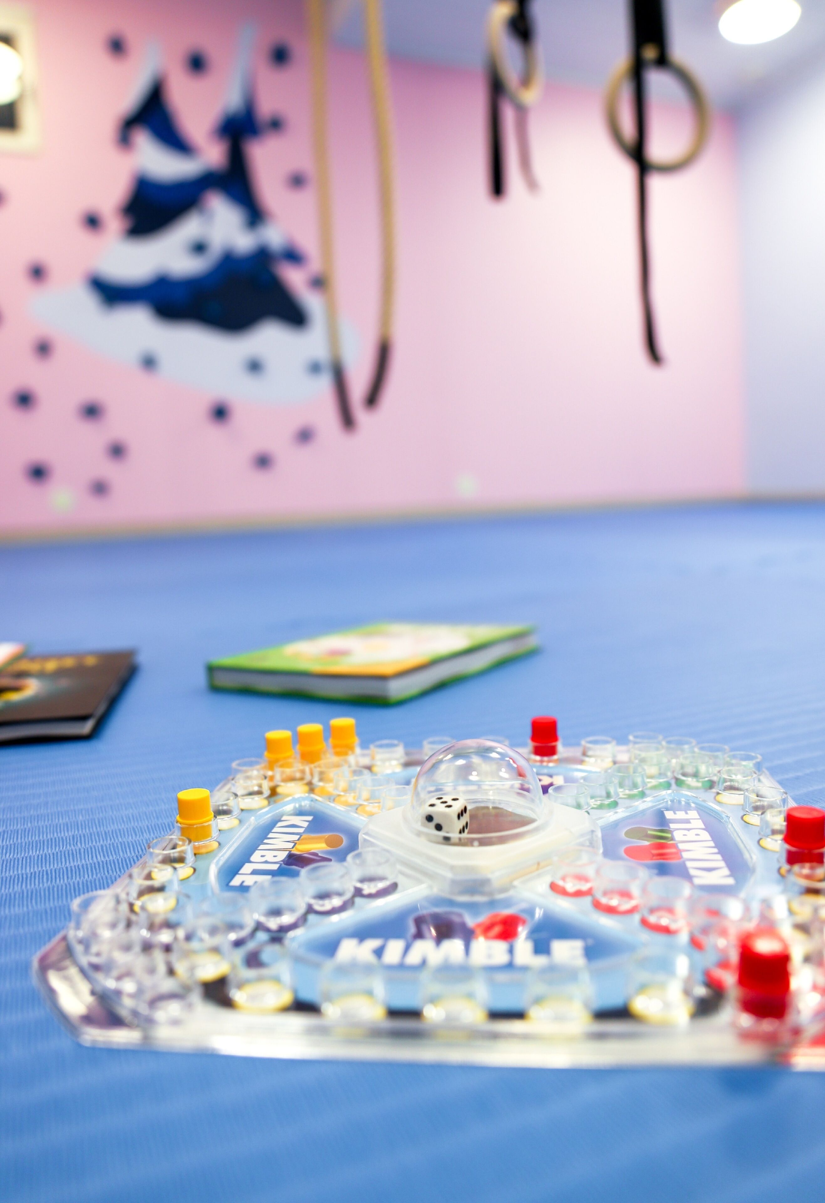 A tabletop with a game board, dice, and cards.