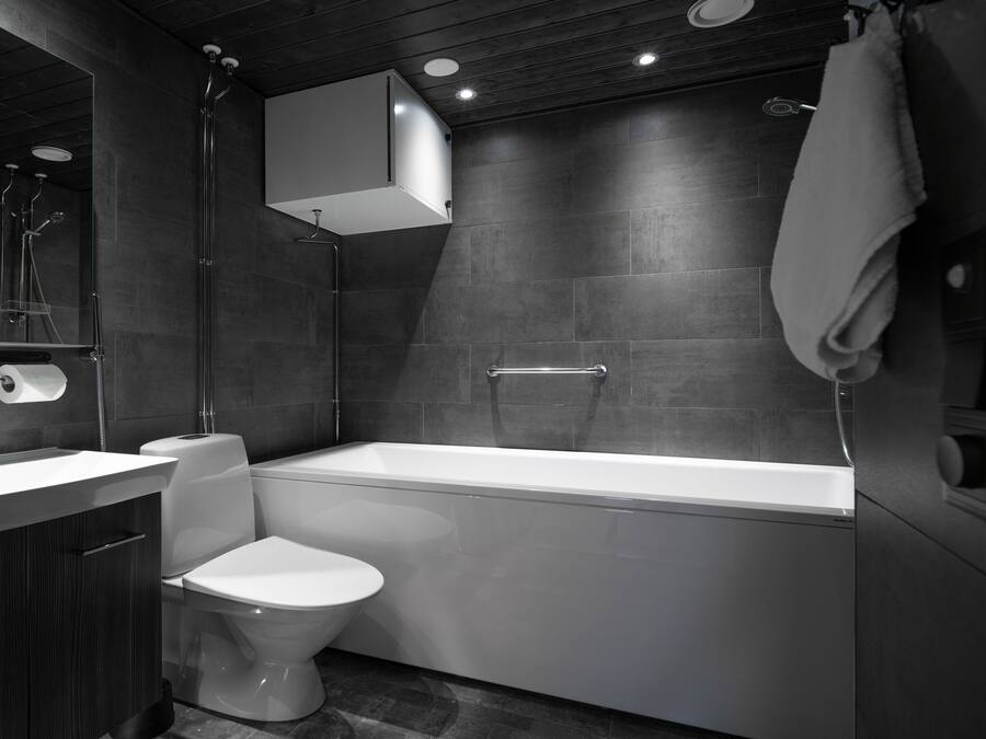 A modern bathroom with a bathtub, toilet, and sink.