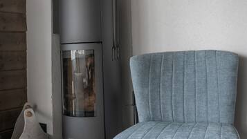 Un salon moderne avec un canapé gris, une cheminée intégrée et un plancher en bois.
