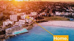An aerial view of a coastal area with buildings, a beach, and a pool. - ★ Sub-Penthouse Beach View ★ by Sydney Dreams ★ (Bondi Beach)