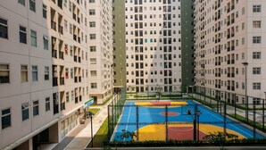 A multi-story residential building with a basketball court in the courtyard. - 2BR Apartment for 4 Pax at Ayodhya Residences (Tangerang)