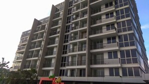 A multi-story building with balconies and large windows. - Big Size with City View @ 3BR Lexington Apartment (Jakarta)