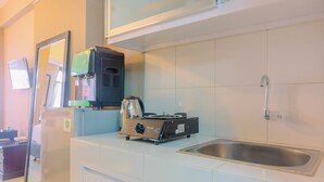 A kitchen with a sink, a stove, and a refrigerator. - New Furnished Studio Apartment at Gunung Putri Square (Gunung Putri)