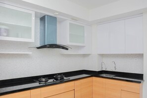 Room | Private kitchenette | Fridge, stovetop, cookware/dishes/utensils - Pleasant and Modern 2BR Grand Kamala Lagoon Apartment (Bekasi)