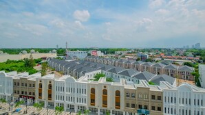 A row of modern buildings with a flat roof design, arranged in a linear fashion. - Cozy and Minimalist Studio Apartment @ Mustika Golf Residence (Cikarang)