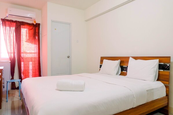 Relax in a serene space with a comfortable bed and a stylish seating area.
