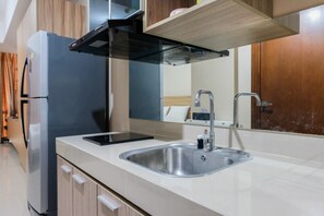 Room | Private kitchen | Fridge, stovetop, cookware/dishes/utensils - Studio Apartment at U Residence near UPH (Curug)