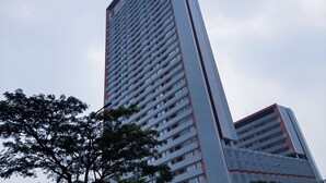 A tall, modern building with a grid-like facade and balconies. - Luxurious and Comfy 2BR Paddington Heights Alam Sutera Apartment (Tangerang)