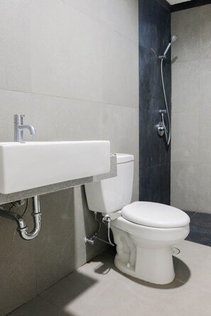 A modern bathroom with a white sink, toilet, and shower. - Luxurious and Comfy 2BR Paddington Heights Alam Sutera Apartment (Tangerang)