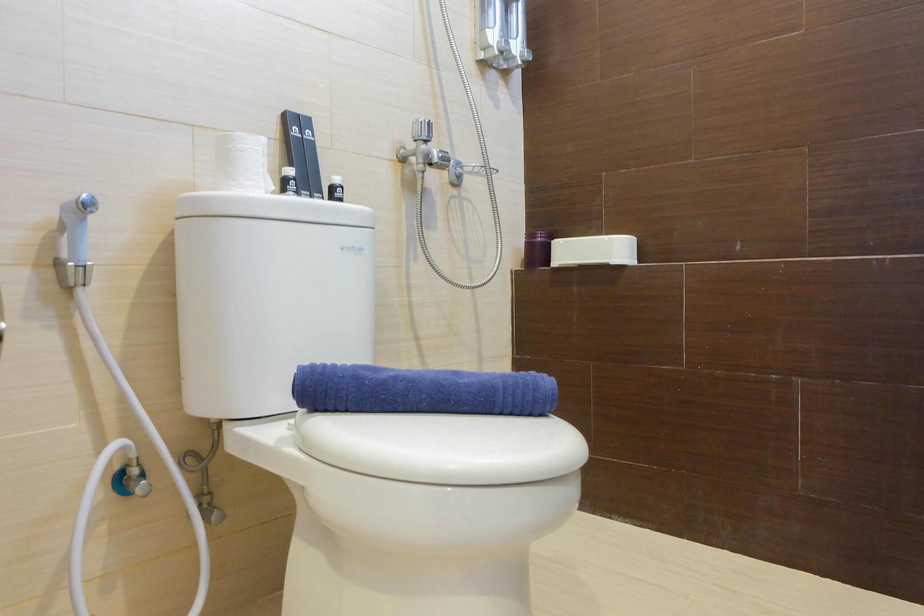 A bathroom with a toilet, a bidet, and a shower.