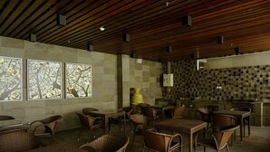 A restaurant with wicker furniture, a tiled backsplash, and a wooden ceiling. - 2Bedroom Sky Terrace Apartment with Pool View (Jakarta)
