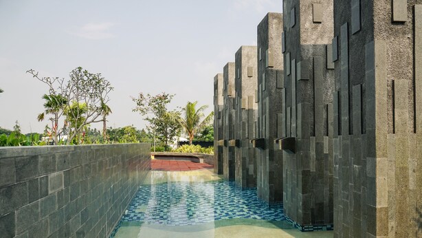A pool area with a tiled floor and a low wall on one side. - Cozy and Comfy 2BR Citralake Suites Apartment (Jakarta)