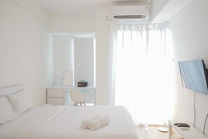 Room | Free WiFi, bed sheets - Stylish Studio Room at Akasa Pure Living BSD Apartment By Travelio (South Tangerang)
