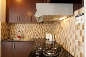 Fridge, stovetop, cookware/dishes/utensils - Relaxing 2BR at The Empyreal Condominium Epicentrum Apartment By Travelio (Jakarta)