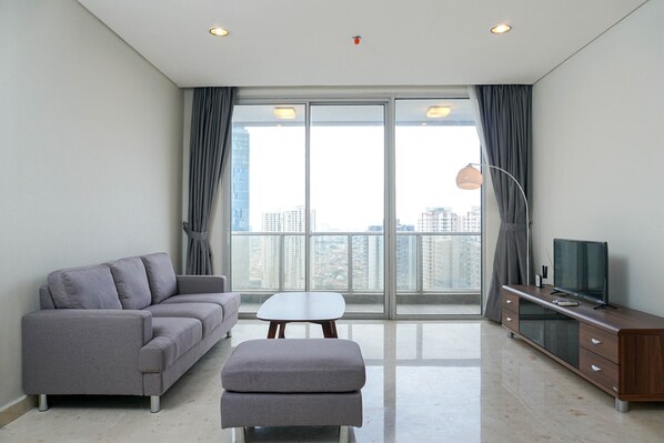 Room | Living area | TV - Relaxing 2BR at The Empyreal Condominium Epicentrum Apartment By Travelio (Jakarta)