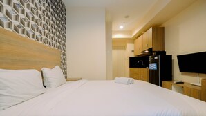 Room | Free WiFi, bed sheets - Premium Studio @ Grand Kamala Lagoon Apartment By Travelio (Bekasi)