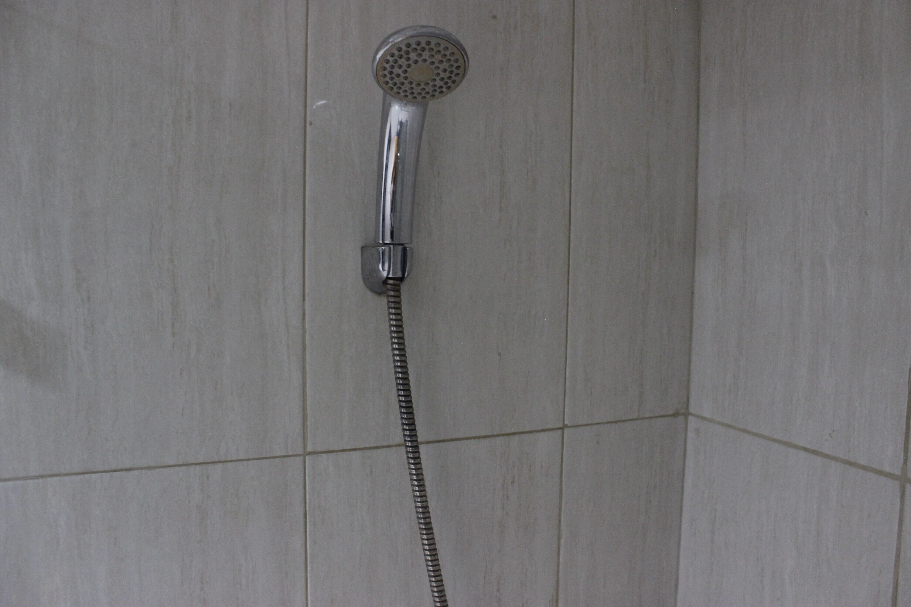 A shower with a handheld hose.
