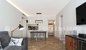 Relax in this stylish living space with a sofa, coffee table, and dining area.