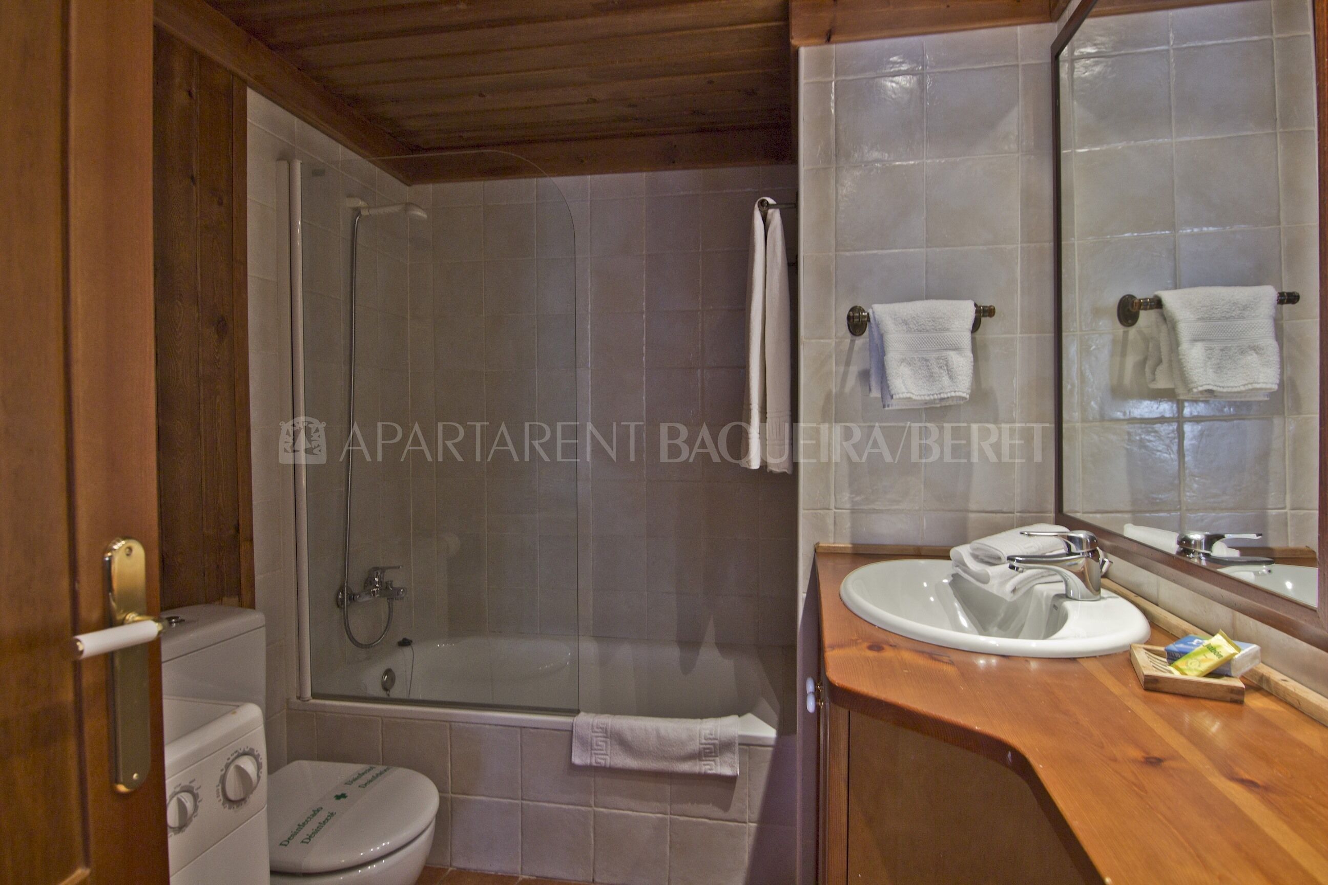 A bathroom with a shower, toilet, and sink.